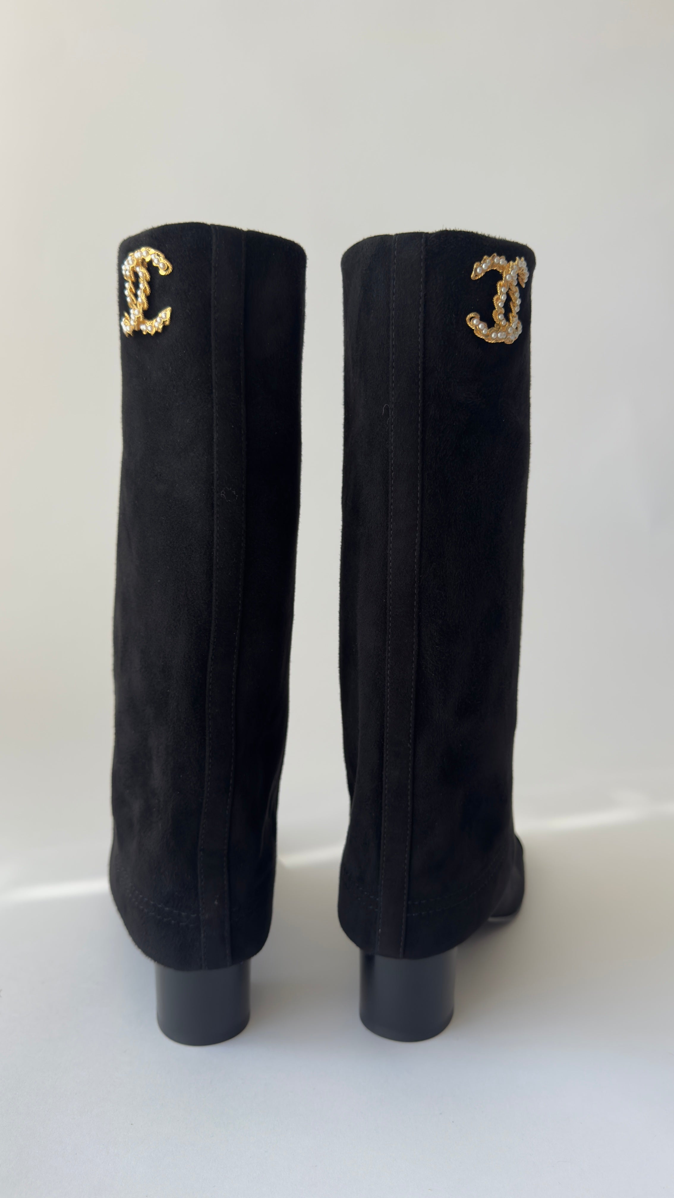 Chanel’s 2024 Métiers d’Art collection high-knee suede and leather combo Chanel logo on top