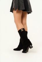 Chanel’s 2024 Métiers d’Art collection high-knee suede and leather combo Chanel logo on top